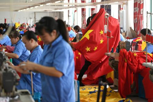 FILE PHOTO: Workers make Chinese flags at a factory in Jiaxing, Zhejiang province, China September 25, 2019. REUTERS/Stringer/File Photo