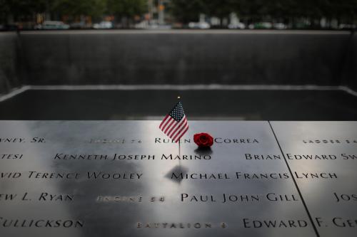 An American flag and red rose stand in the names of those lost at the edge of the south reflecting pool of the 9/11 Memorial & Museum ahead of the 20th anniversary of the 9/11 attacks in lower Manhattan in New York City, New York, U.S., September 8, 2021. REUTERS/Mike Segar