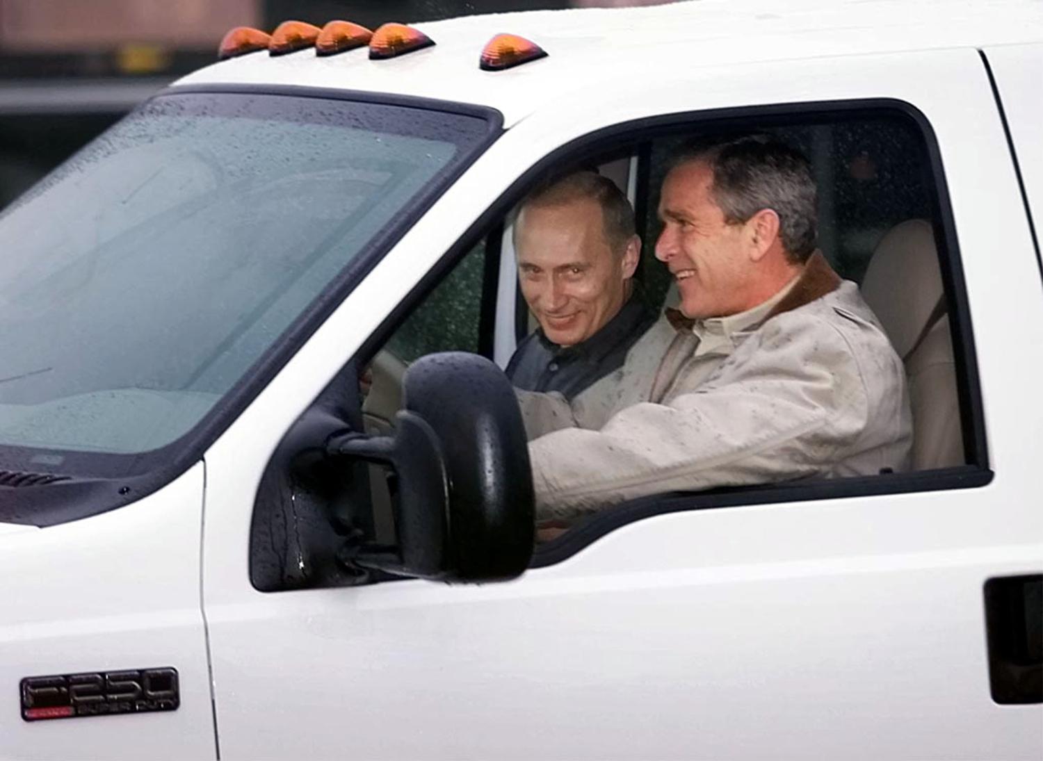 U.S. President George W. Bush rides with Russian President Vladimir Putin in the front of his pickup truck as he welcomes Putin to his ranch in Crawford, Texas November 14, 2001. [Bush plans to treat Putin to Western-style entertainment and tour of his beloved ranch, as well as follow up on their talks in Washington on Tuesday on a new strategic relationship. ] Win McNamee / Reuters.