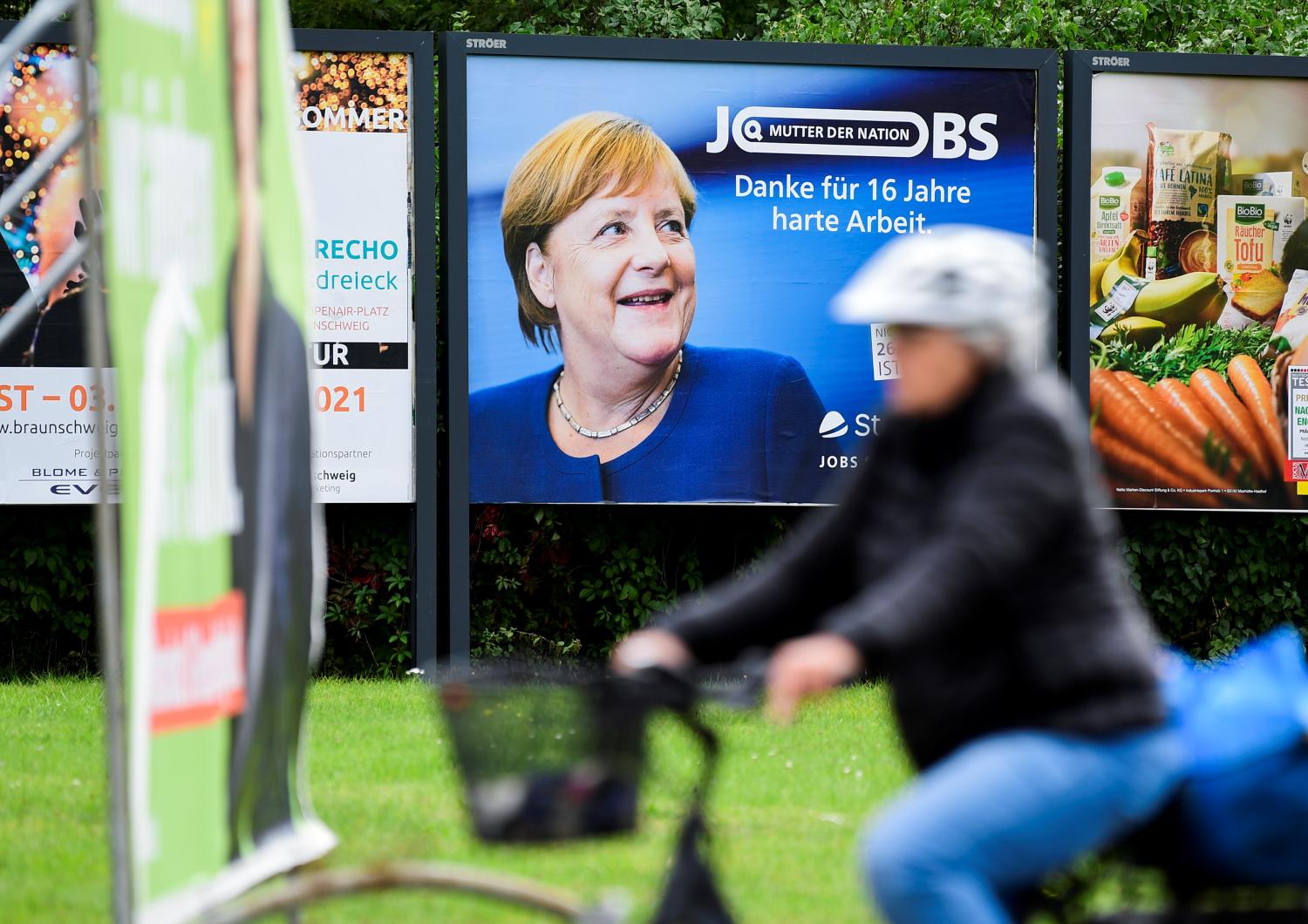 An advertisement showing German Chancellor Angela Merkel with a slogan reading: "Thanks For 16 Years of Hard Work" is seen behind election posters for Germany's upcoming state elections in Brunswick, Germany, September 16, 2021. REUTERS/Fabian Bimmer