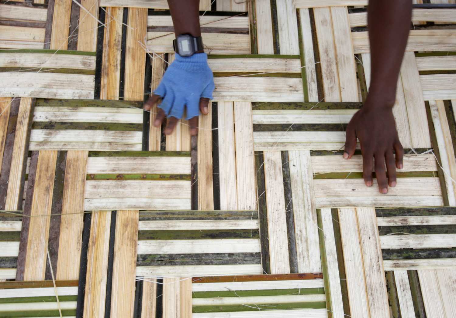 A man works on bamboo mat in Monrovia, Liberia, October 14, 2017. REUTERS/Thierry Gouegnon