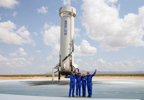 Billionaire American businessman Jeff Bezos (2nd-L) poses for pictures with crew mates, from left, Oliver Damen, 18, Bezos, Wally Funk, 82, and Mark Bezos at the landing pad after they flew on Blue Origin's inaugural flight to the edge of space, in the nearby town of Van Horn, Texas, U.S. July 20, 2021.   REUTERS/Joe Skipper