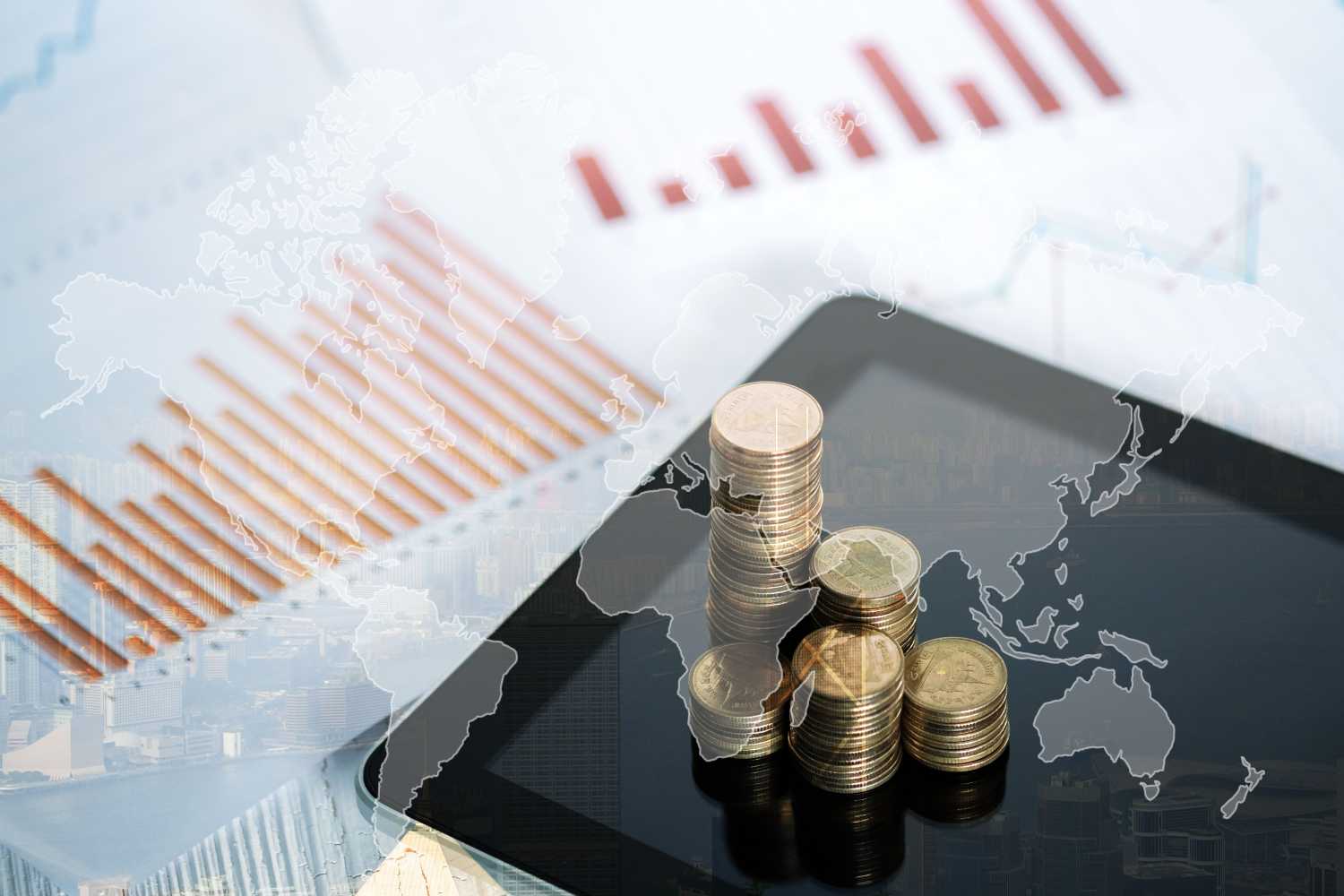 Double exposure of coin stack and tablet with city background and world map, financial graph, world map and global network business concept idea, element by NASA.