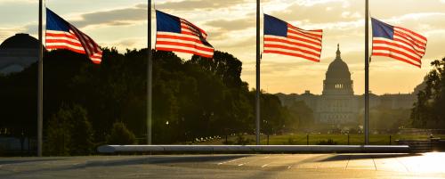 United,States,Capitol,Building,Silhouette,And,Us,Flags,Around,Washington