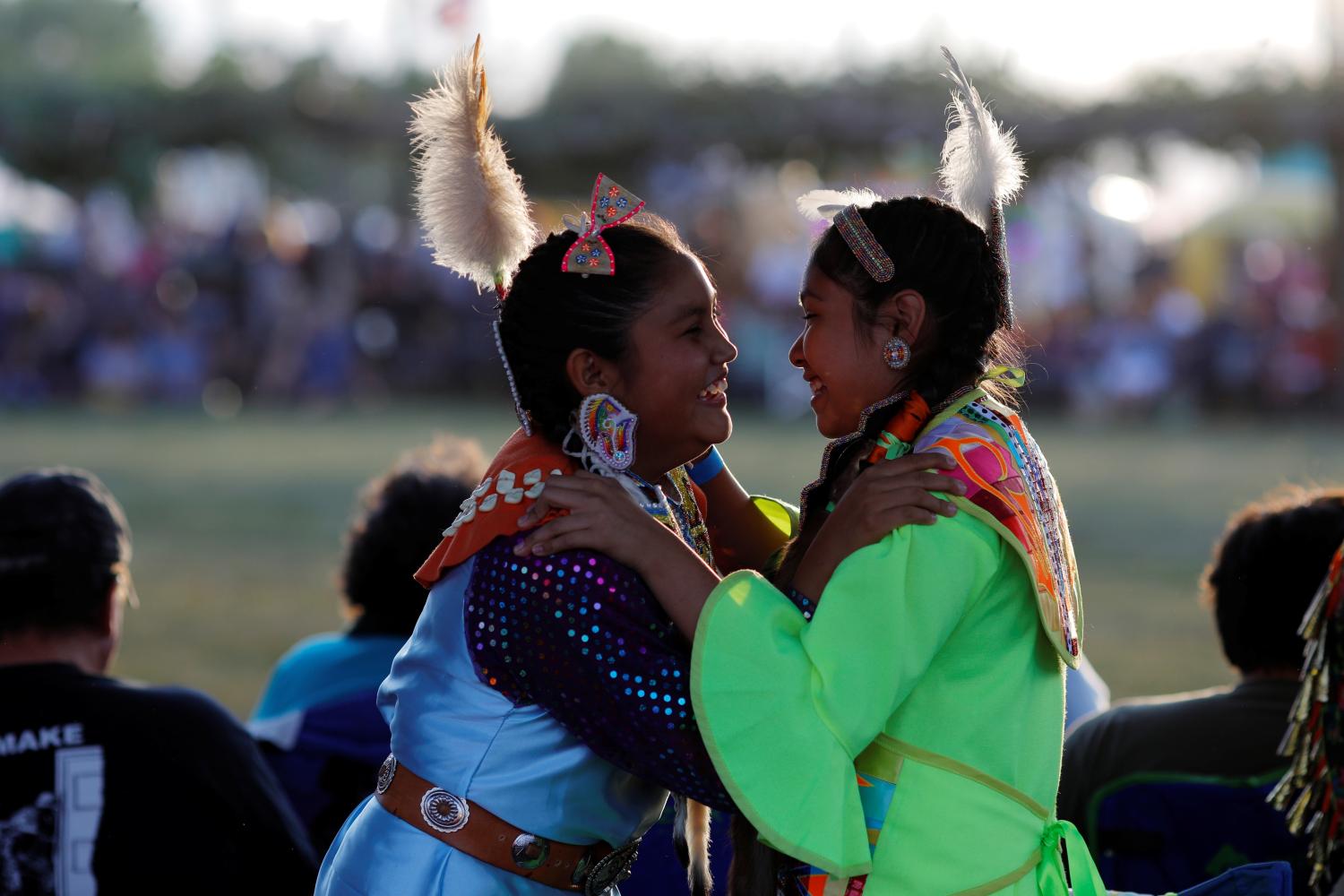 Thirteen-year-old Nizhoni Stencil, who is Navajo, and twelve-year-old Tasia Pecos, who is Jemez, prepare for the Grand Entry on the opening night of the 32nd Annual Taos Pueblo Pow Wow, a Native American dance competition and social gathering, in Taos, New Mexico, U.S., July 7, 2017.  Picture taken July 7, 2017.   REUTERS/Brian Snyder