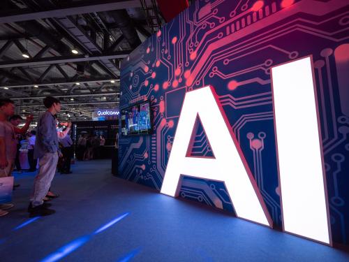 A signage of Artificial Intelligence (AI) is seen at the stand of Xiaomi during the 2018 China Mobile Global Partner Conference in Guangzhou city, south China's Guangdong province.