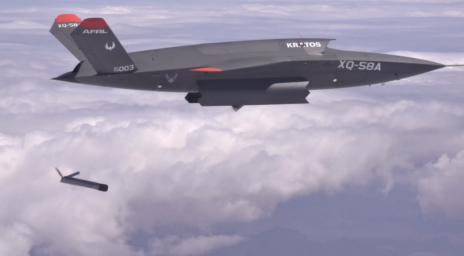 A Kratos XQ-58 Valkyrie unmanned aircraft demonstrates launching a drone from an internal bay.