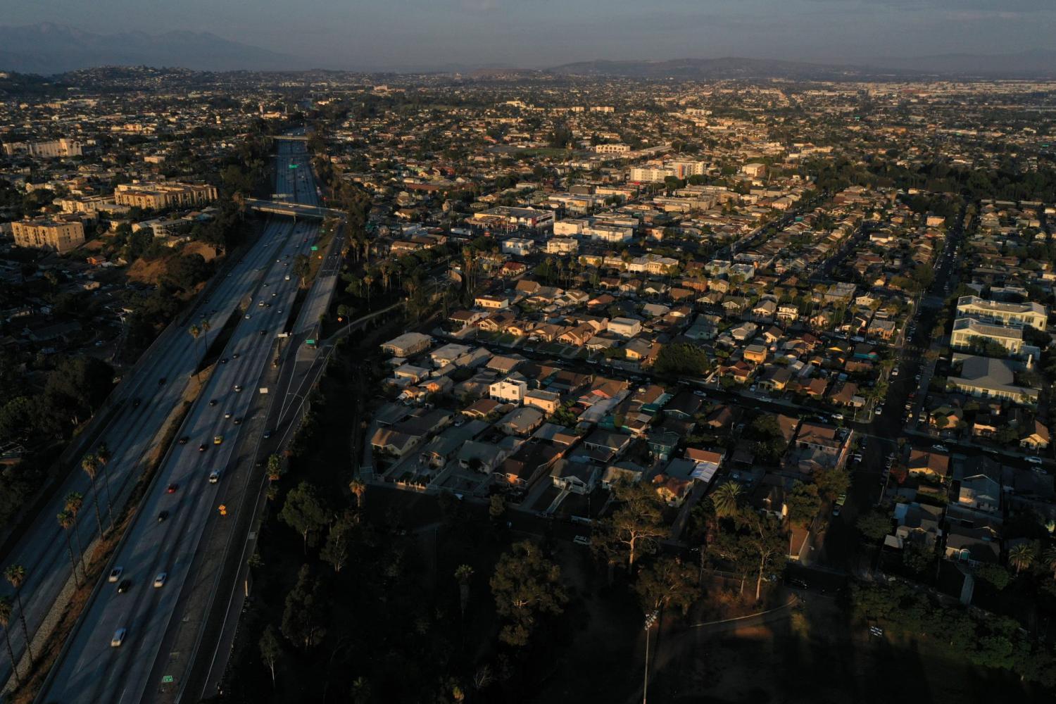 An aerial view shows vehicle traffic on Interstate 5 (I-5) and homes in residential areas in Los Angeles, California, U.S. August 10, 2021. Picture taken with a drone. REUTERS/Bing Guan