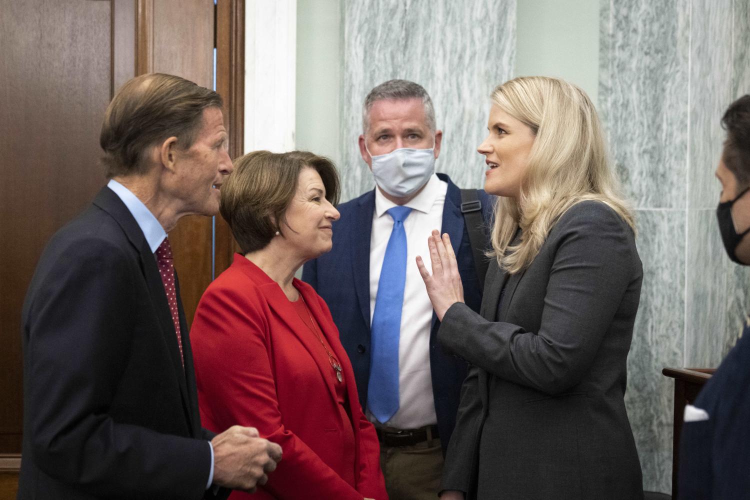 Sen. Richard Blumenthal (D-CT) and Sen. Amy Klobuchar (D-MN) speak with former Facebook employee Frances Haugen as she arrives for a Senate Committee on Commerce, Science, and Transportation hearing entitled 'Protecting Kids Online: Testimony from a Facebook Whistleblower' on Capitol Hill October 5, 2021 in Washington, DC.