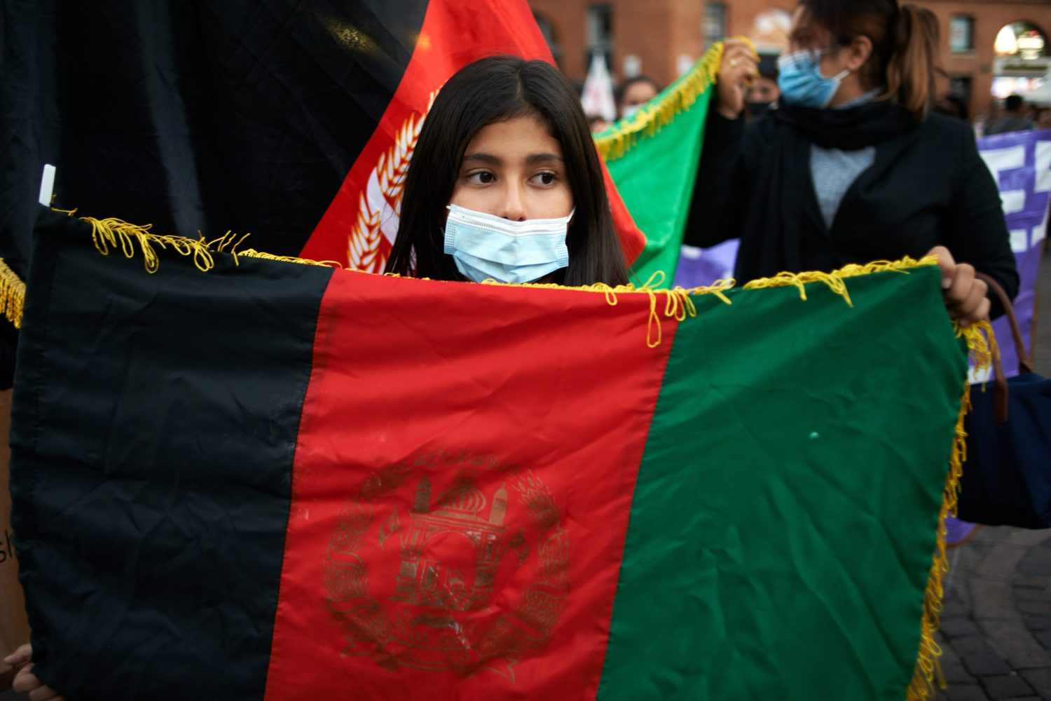 An Afghnai girl holds the national flag of Afghanistan. Dozens of people (women's empowerment, LGBT+ and lesbians organizations) and members of the Afghani community of Toulouse organized a gathering and a protest in Toulouse to raise awereness about the Afghanistan's situation and mainly about Afghan' women dire situation under Taliban's rule. After the Trump's decision (and applied by Biden) to pull out all US soldiers from Aghanistan after 20 years of war, the lightning advance of Talibans towards Kabul and the seizure of it, thousands of Afghans tried to escape. The Afghani community and feminist organiszations are worried about girls and women situation under Taliban's rule.Toulouse. France. October 7th 2021. (Photo by Alain Pitton/NurPhoto)NO USE FRANCE