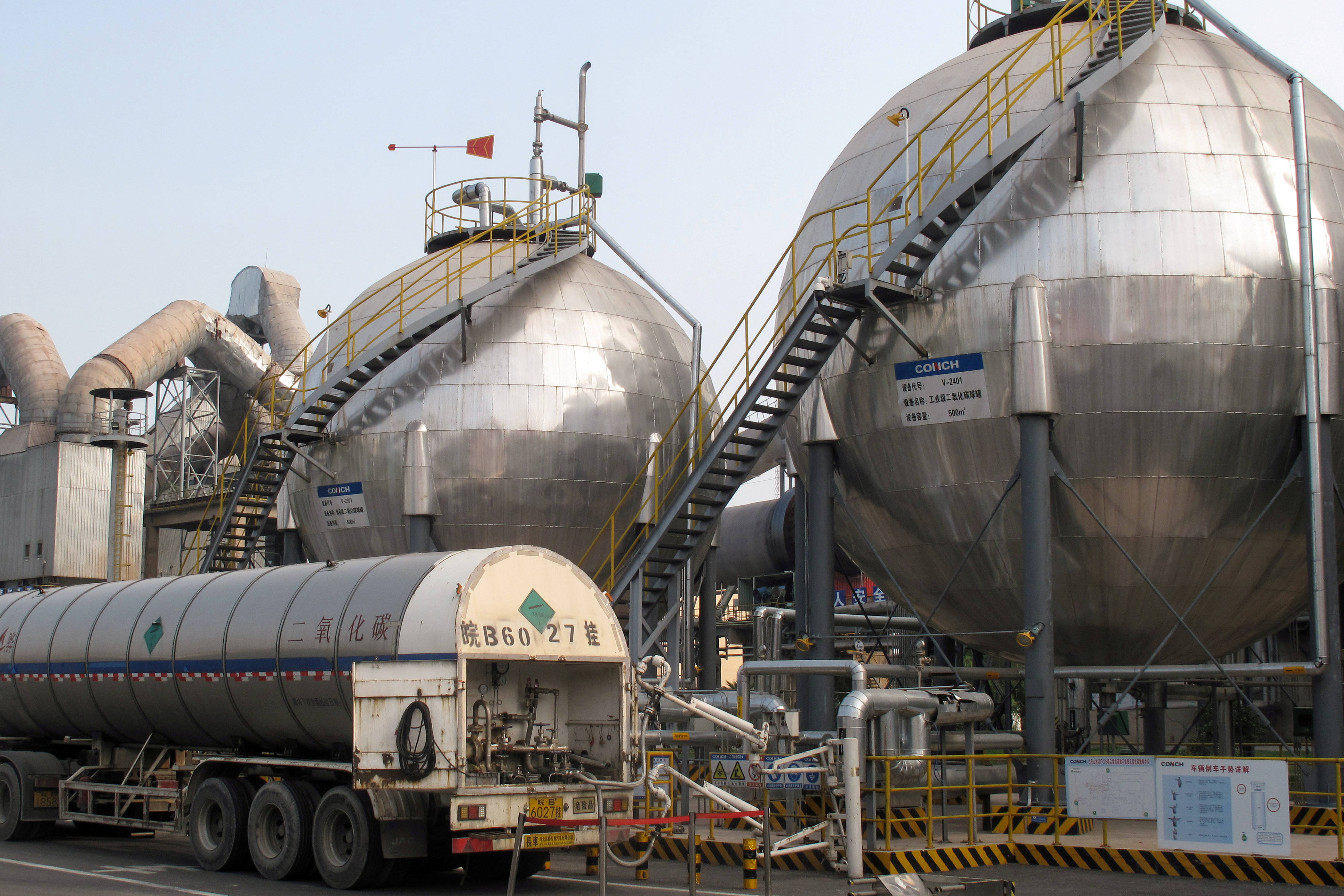 FILE PHOTO: CO2 storage tanks are seen at a cement plant and carbon capture facility in Wuhu, Anhui province, China September 11, 2019. Picture taken September 11, 2019. REUTERS/David Stanway/File Photo