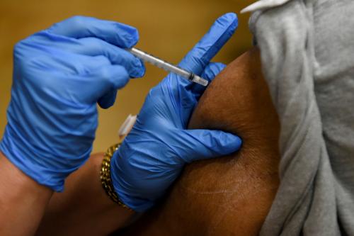 FILE PHOTO: A person receives a vaccine for the coronavirus disease (COVID-19)  at Acres Home Multi-Service Center in Houston, Texas, U.S., October 13, 2021.  REUTERS/Callaghan O'Hare/File Photo