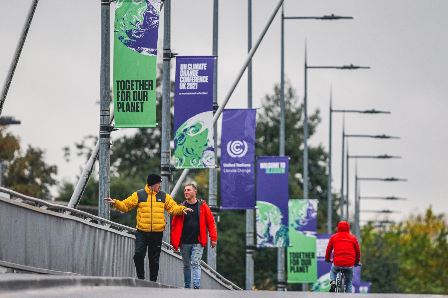 A pedestrian crosses the Clyde Arc Bridge overlooking the Scottish Event Campus on September 1, 2021 in Glasgow, Scotland. The Scottish Event Campus IS one of the host venues for the upcoming COP 26 climate summit which is due to be held in Glasgow from the 1-12th November.  (Photo by Ewan Bootman/NurPhoto)NO USE FRANCE