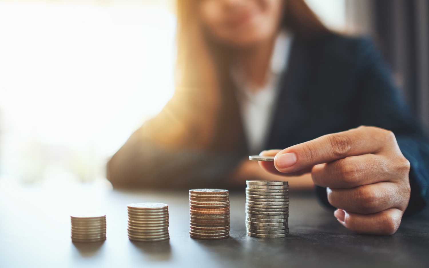 Businesswoman stacking coins