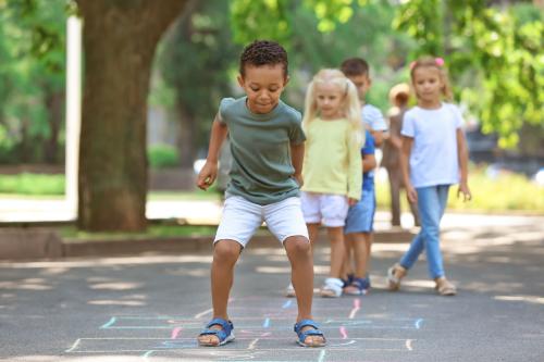 Children playing hopscotch in the park.