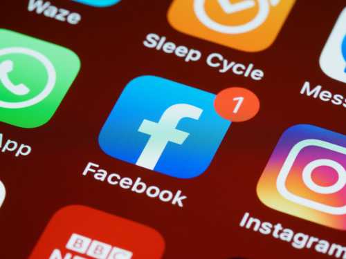 A smartphone with the Facebook app logo displayed.