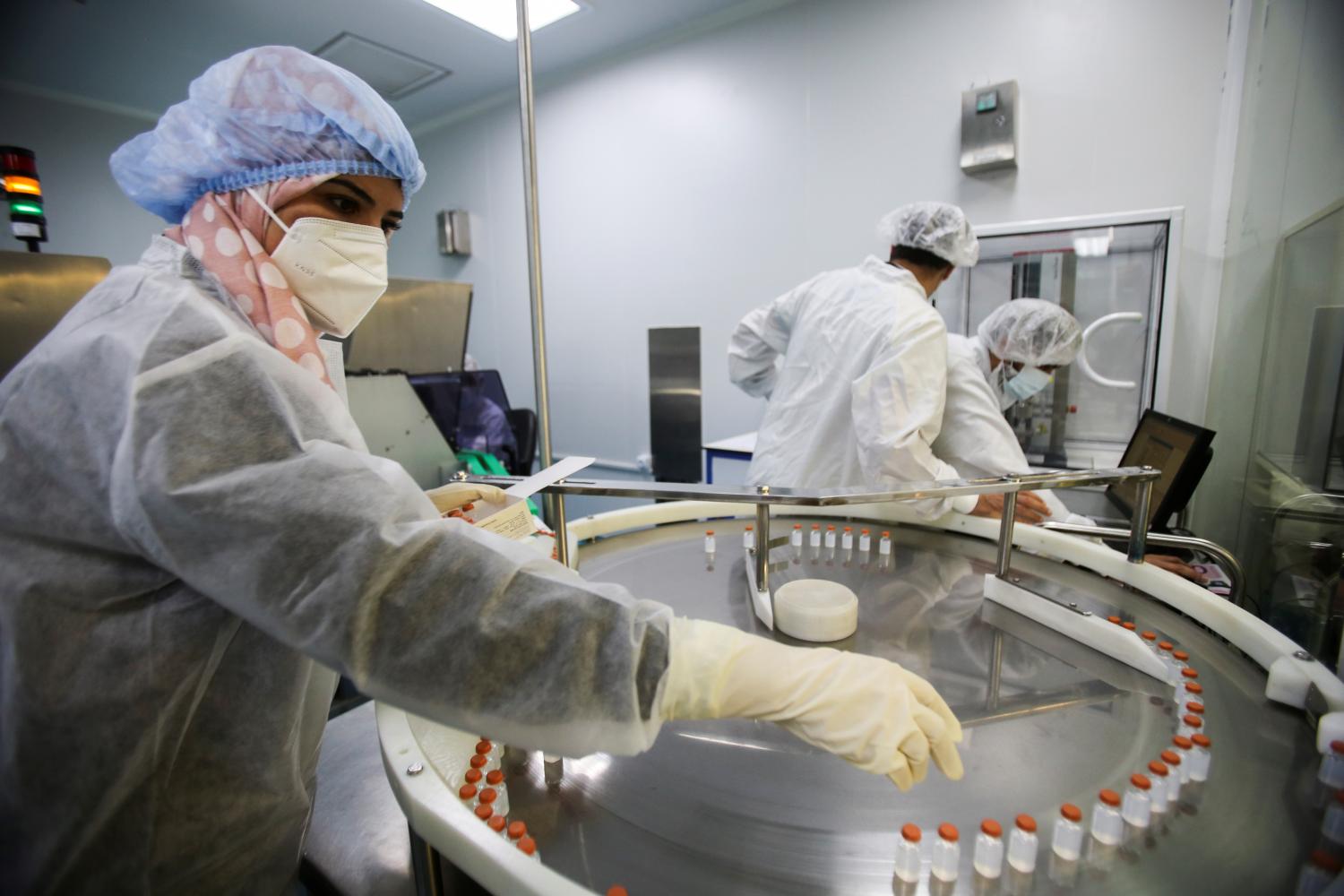 A lab technician arranges the vials of Chinese Sinovac's CoronaVac vaccine against coronavirus disease (COVID-19) during the inauguration of a production lab designated to manufacture the vaccine, in Constantine, Algeria September 29, 2021. REUTERS/Ramzi Boudina