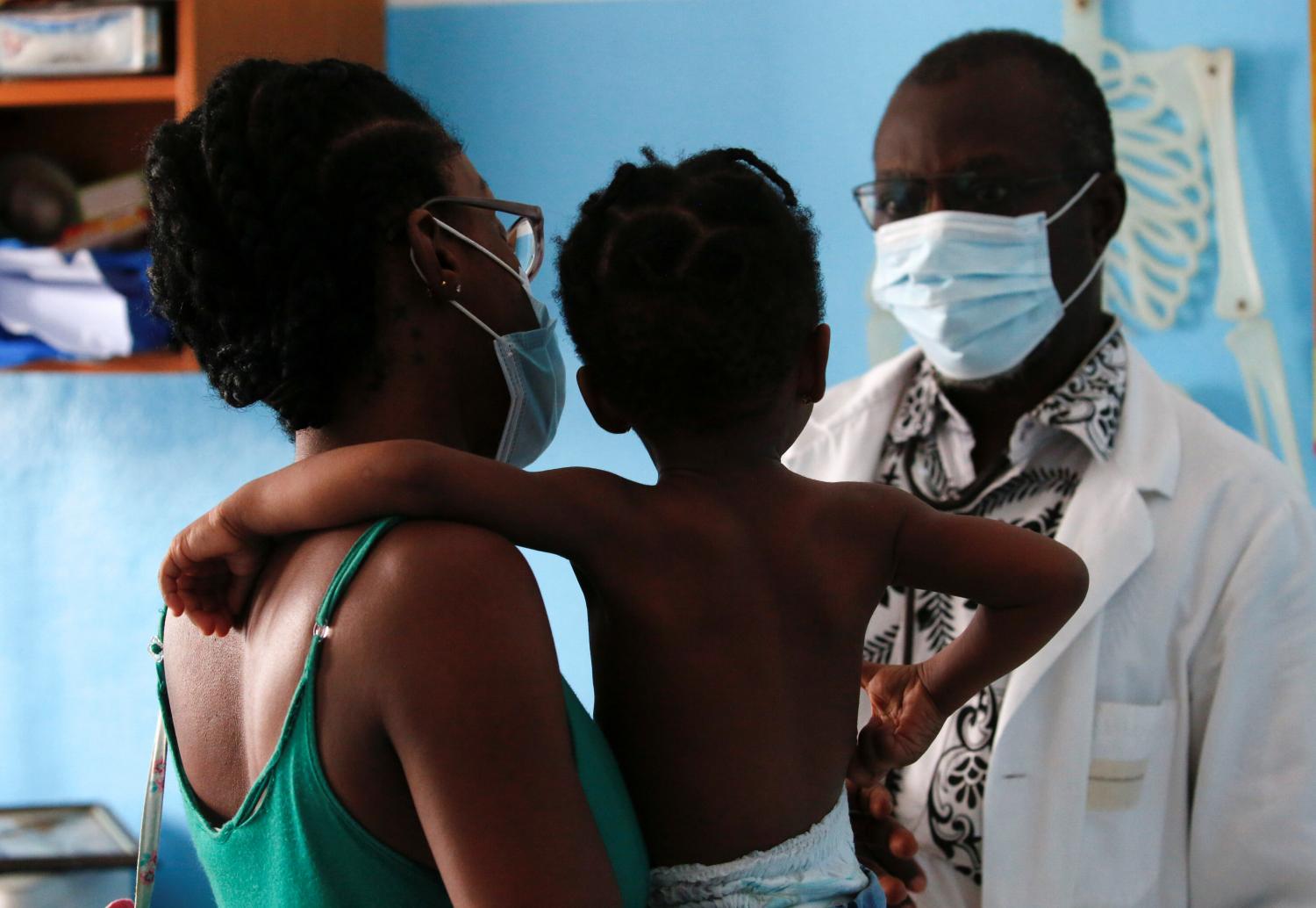 Doctor Charles Eblin prepares to take care of a girl with malaria at his clinic Centre de sante sainte Marie de Marcory in Abidjan, Ivory Coast October 7, 2021. REUTERS/Luc Gnago