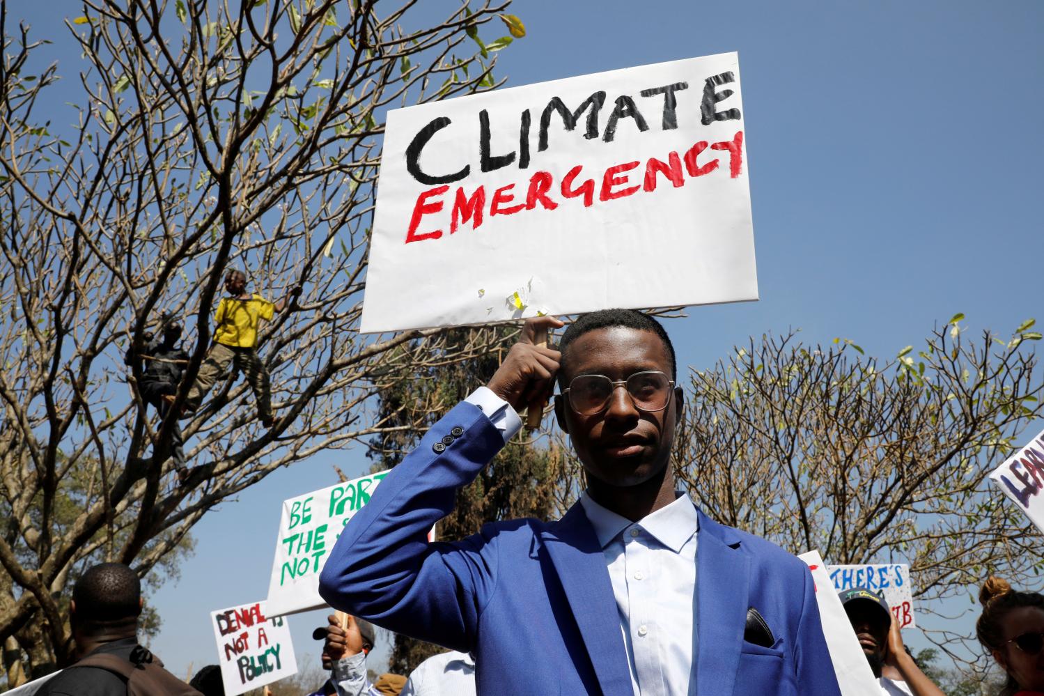 An environmental activist holds a sign as he takes part in the Climate strike protest calling for action on climate change, in Nairobi, Kenya, September 20, 2019. REUTERS/Baz Ratner