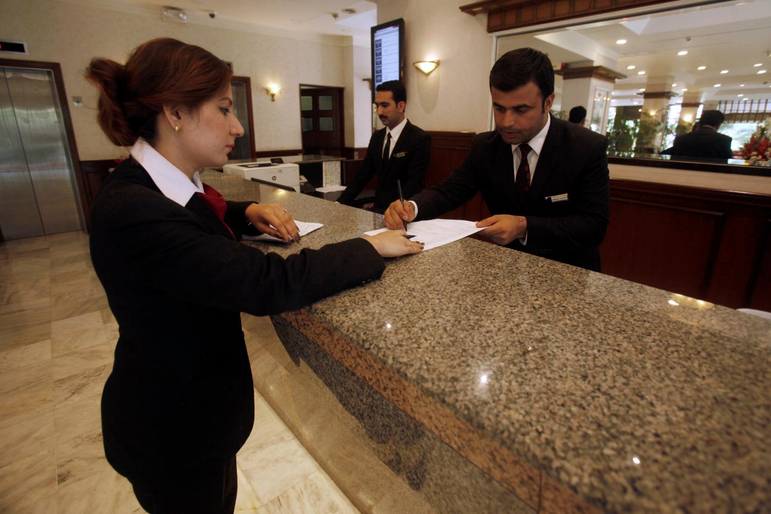The reception desk staff is seen at the Pearl Continental hotel in Peshawar, Pakistan April 10, 2018. REUTERS/Fayaz Aziz