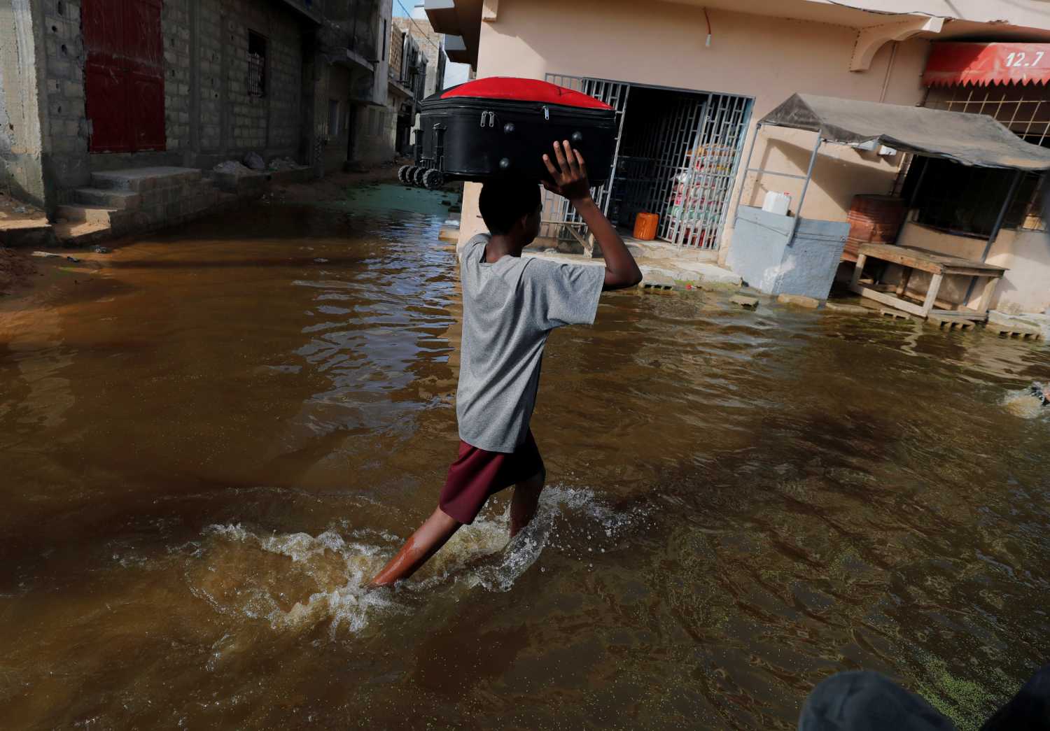 A resident makes his way through a flooded street after last week's heavy rains in Keur Massar, Senegal September 8, 2020. REUTERS/Zohra Bensemra