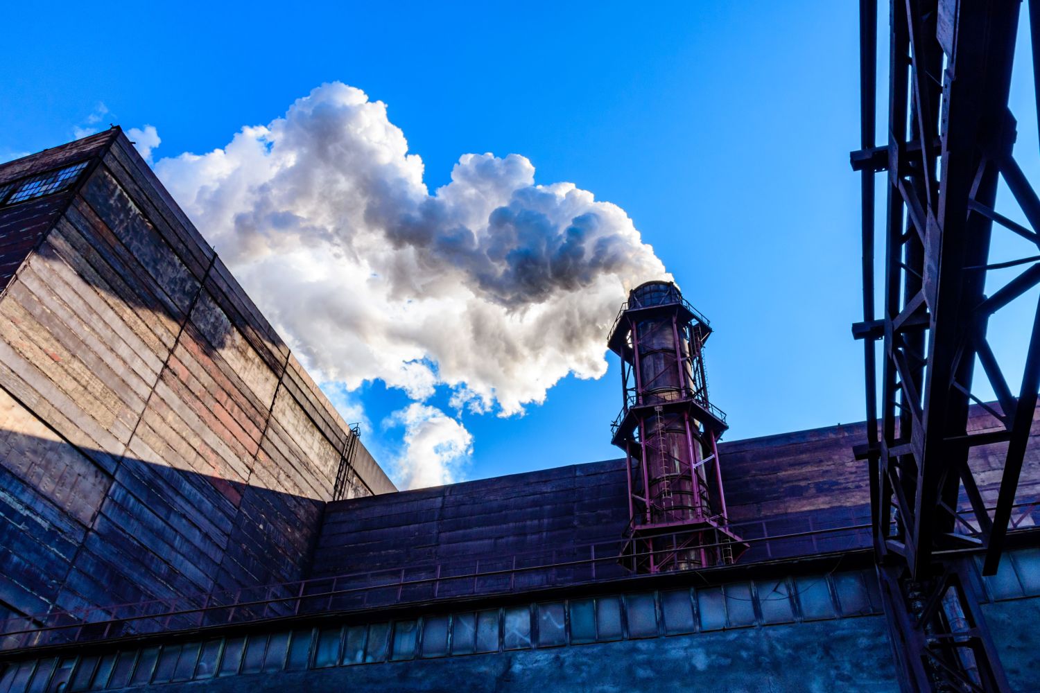 Factory smoke against a blue sky