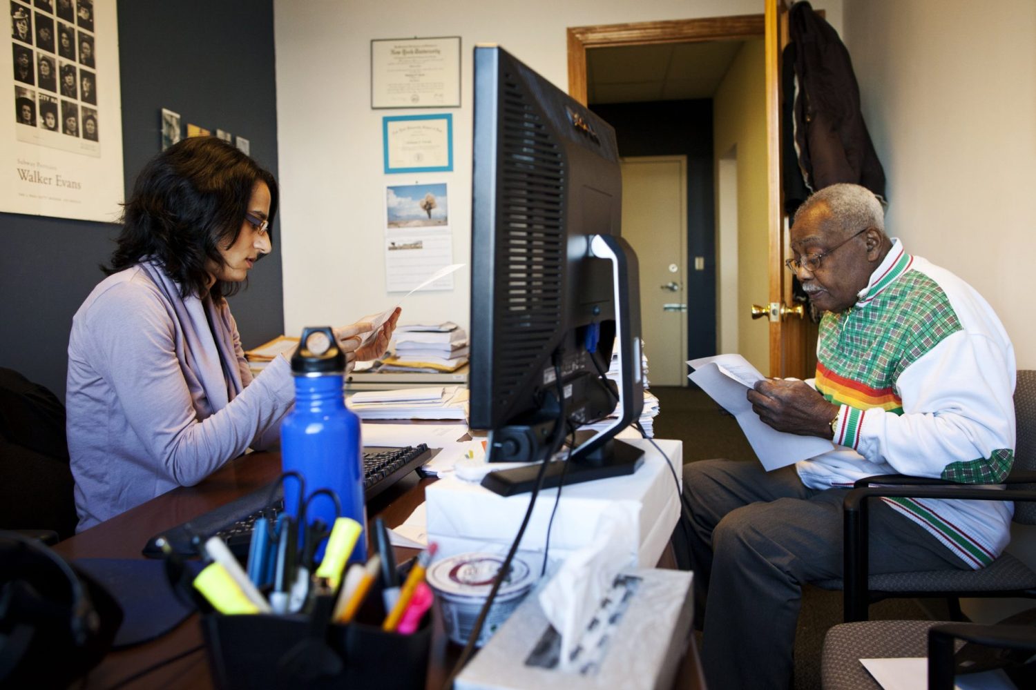 Hamson McPherson (R), 77, looks over paper work from Wells Fargo regarding a denied loan modification request for his mortgage, with Shabnam Faruki, a lawyer at Staten Island Legal Services, in Staten Island, New York, December 9, 2011. McPherson has owned his home since 1974 but was recently denied by Wells Fargo for a loan modification request. McPherson is now working with Shabnam Faruki, a lawyer at Staten Island Legal Services to appeal the bank on their denial. Three years after the foreclosure crisis began, the process to apply for a loan modification remains a bureaucratic nightmare that is complicating the housing recovery and could dull the impact of any Obama administration initiatives in the works. Picture taken December 9, 2011. To match Analysis USA/HOUSING-FORECLOSURES   REUTERS/Andrew Burton (UNITED STATES - Tags: BUSINESS REAL ESTATE)