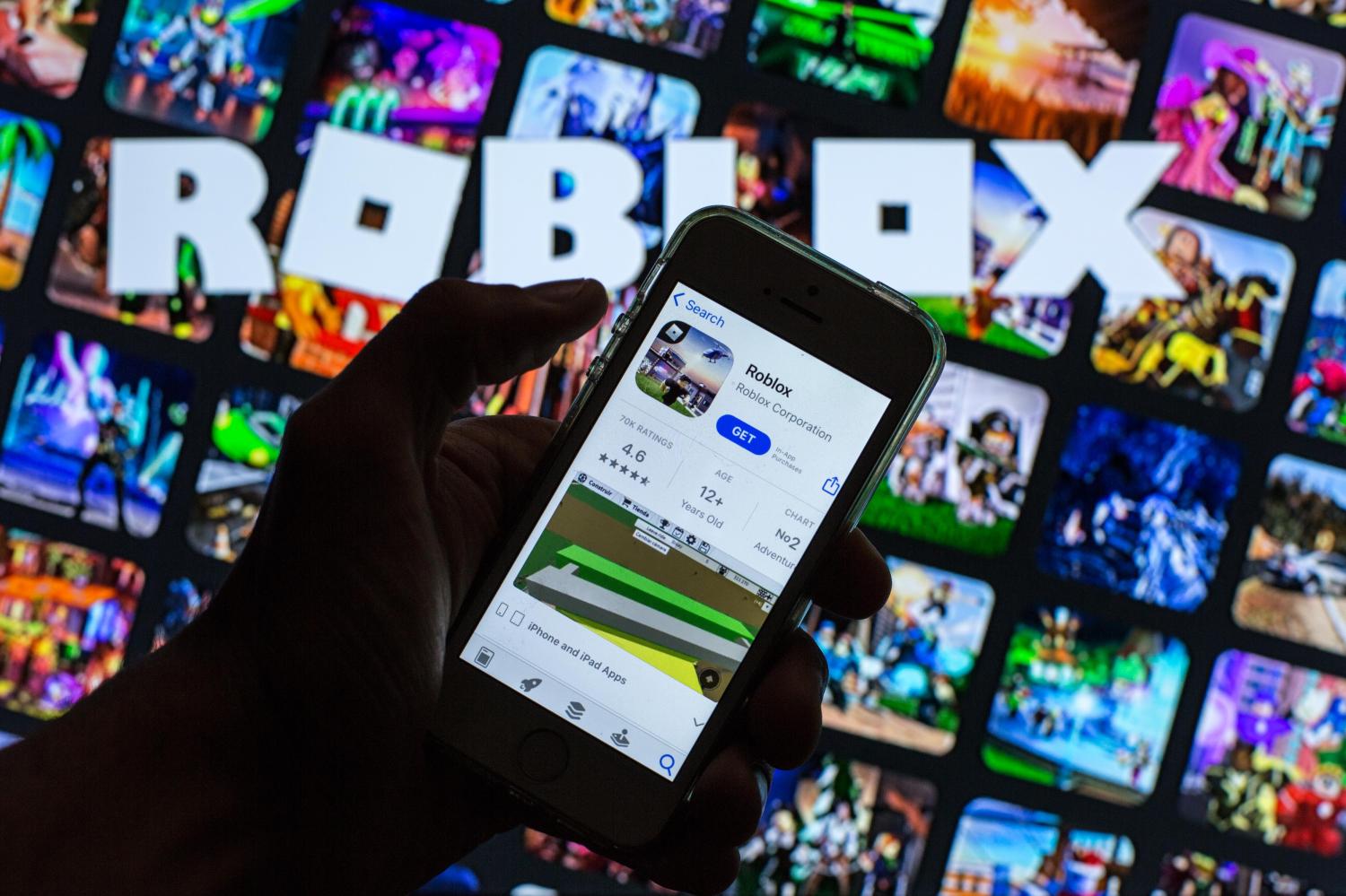 The Roblox app in the App Store is displayed on a smartphone screen and a Roblox logo in the background.
