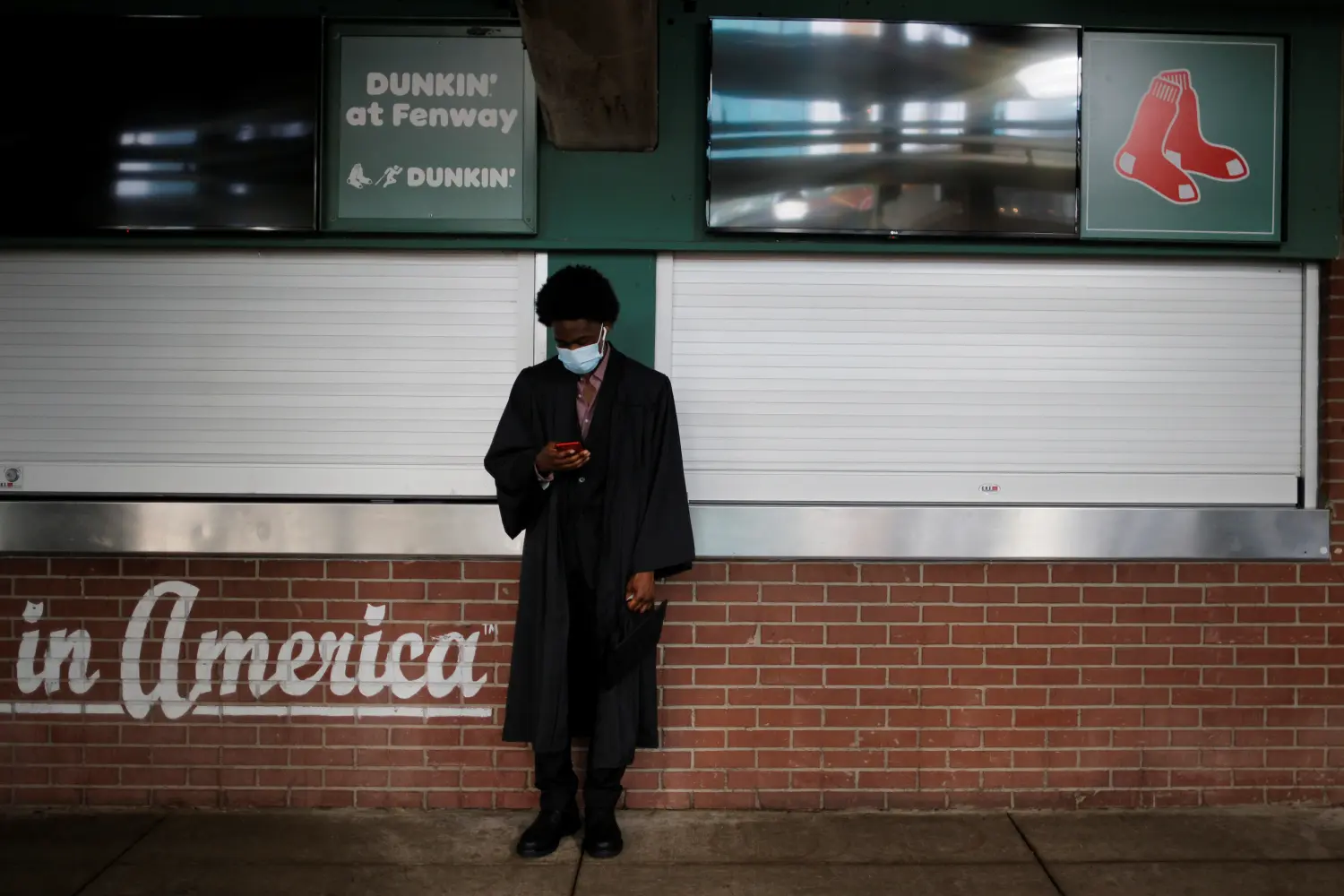 A Brighton High School senior waits for the graduation ceremony being held at Fenway Park, home of Major League Baseball’s Boston Red Sox for greater safety during the coronavirus disease (COVID-19) pandemic, in Boston, Massachusetts, U.S., June 15, 2021.   REUTERS/Brian Snyder