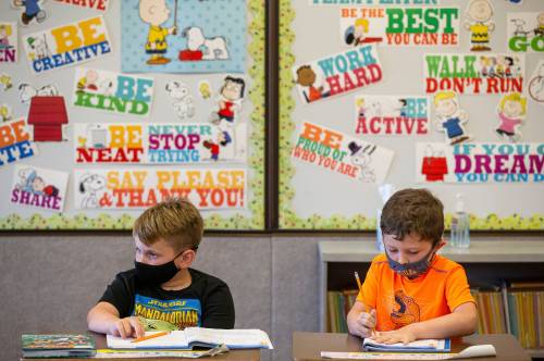 Leo, left, and Jeffery, right, listen as their teacher, Justin Armbruster, goes through a math lesson at Rochester Elementary School in Rochester, Ill., Wednesday, September 15, 2021. Illinois students and school staff in K-12 and early childhood care centers are required to wear masks indoors because of the COVID-19 pandemic. Illinois students and school staff in K-12 and early childhood care centers are required to wear masks indoors because of the COVID-19 pandemic. [Justin L. Fowler/The State Journal-Register]Rochester School District