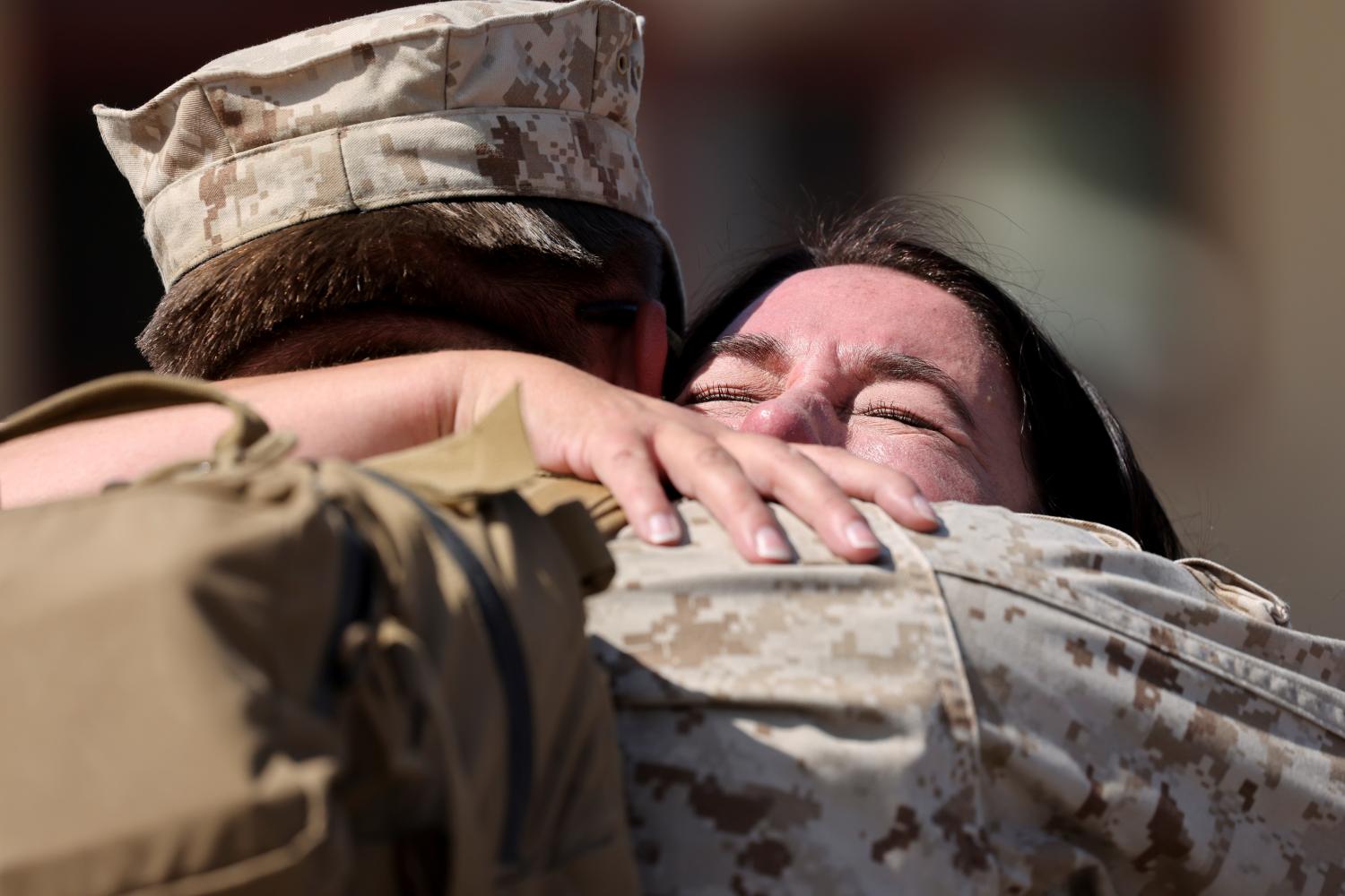 A marine, who had been deployed to Afghanistan, hugs his mother as he returns to U.S. Marine Base Camp Pendleton in Oceanside, California, U.S., October 3, 2021. REUTERS/Mike Blake