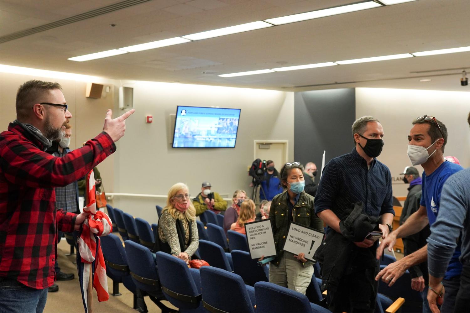 An anti-vaccine mandate protester, argues with another meeting attendee during an event organised by Portland Public School to discuss a proposed coronavirus disease (COVID-19) vaccine mandate for students 12-years-old and above in Portland, Oregon, U.S. October 26, 2021. REUTERS/Sergio Olmos NO ARCHIVES. NO RESALES.