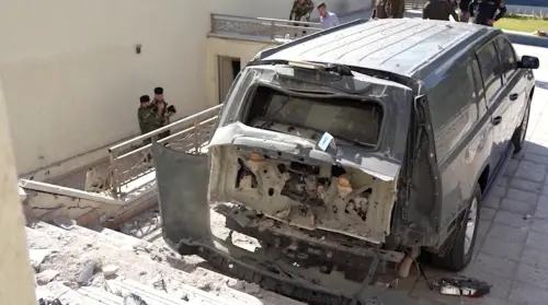 A destroyed vehicle is parked in front of Iraqi Prime Minister Mustafa al-Kadhimi's residence following an assassination attempt by an armed drone in Baghdad, Iraq in this screen grab taken from a handout video obtained by Reuters on November 7, 2021. PRIME MINISTER MEDIA OFFICE/Handout via REUTERS THIS IMAGE HAS BEEN SUPPLIED BY A THIRD PARTY. MANDATORY CREDIT