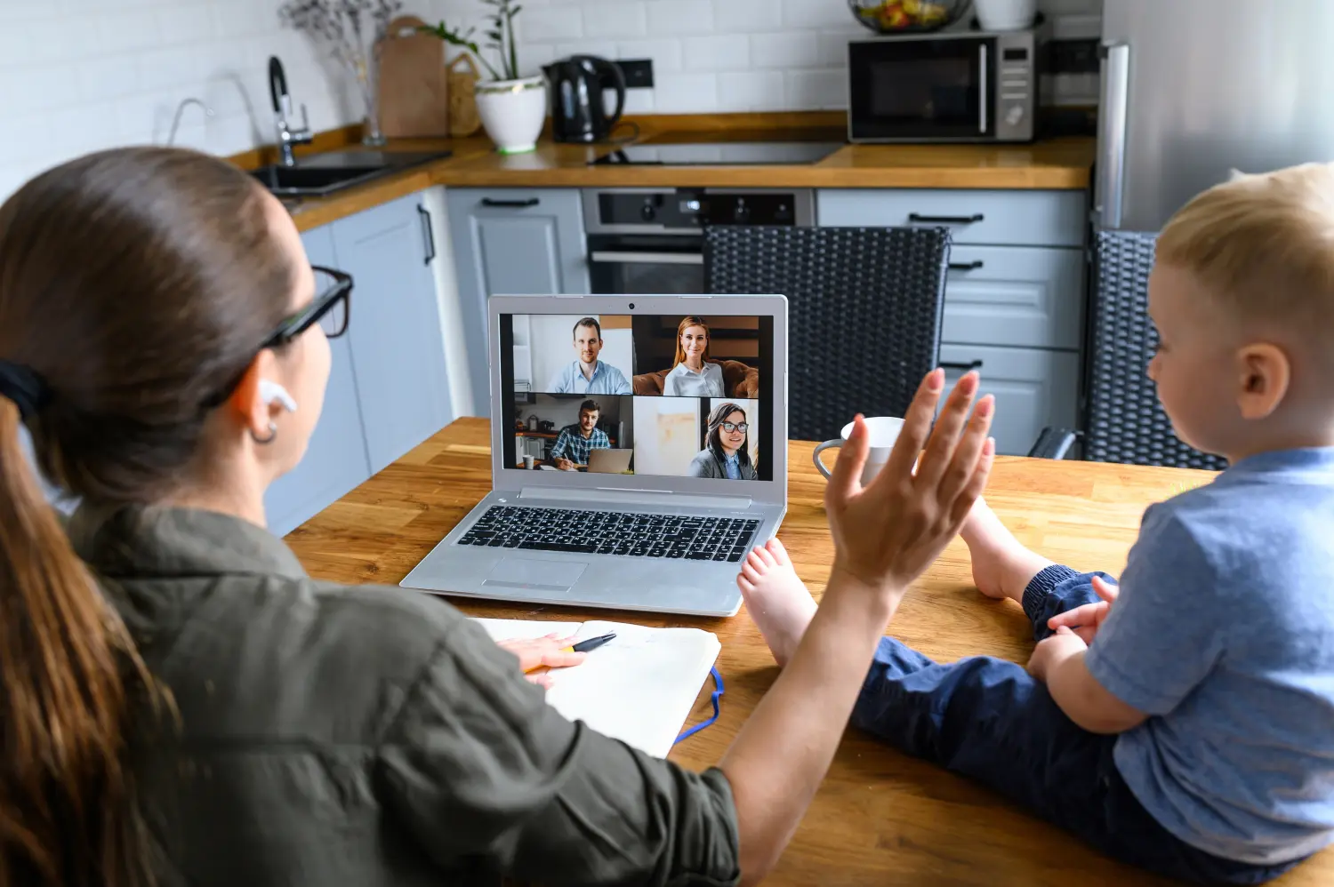 Woman on a video call with child at her side