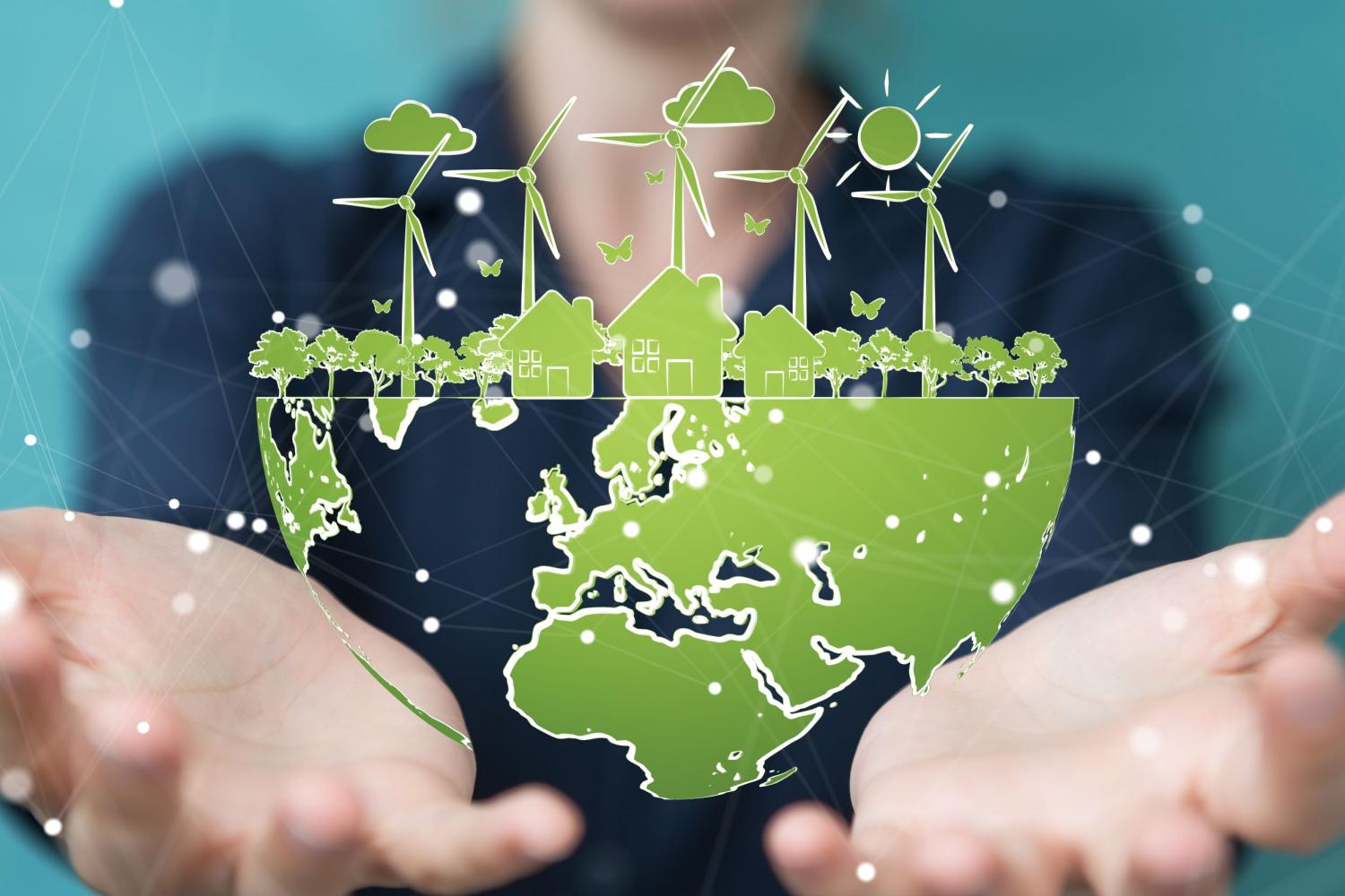 A student holds a replica of Earth with wind mills.