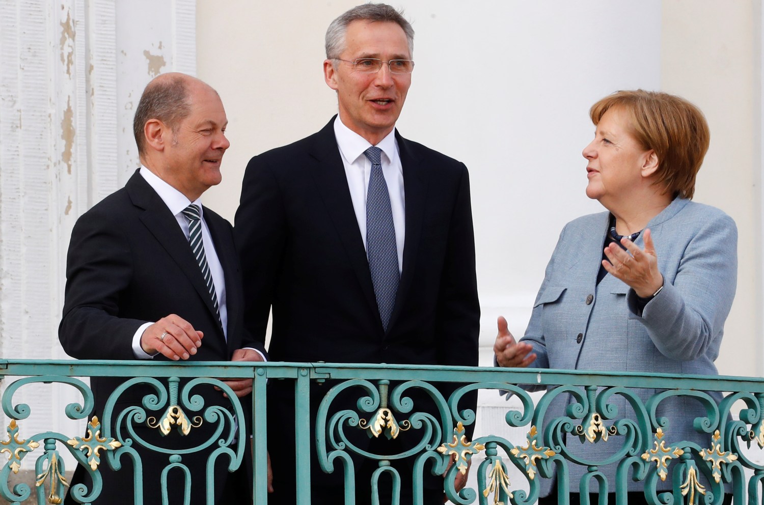 German Chancellor Angela Merkel and Finance Minister Olaf Scholz welcome NATO Secretary General Jens Stoltenberg at the German government guesthouse Meseberg Palace in Meseberg, Germany, April 10, 2018. REUTERS/Fabrizio Bensch