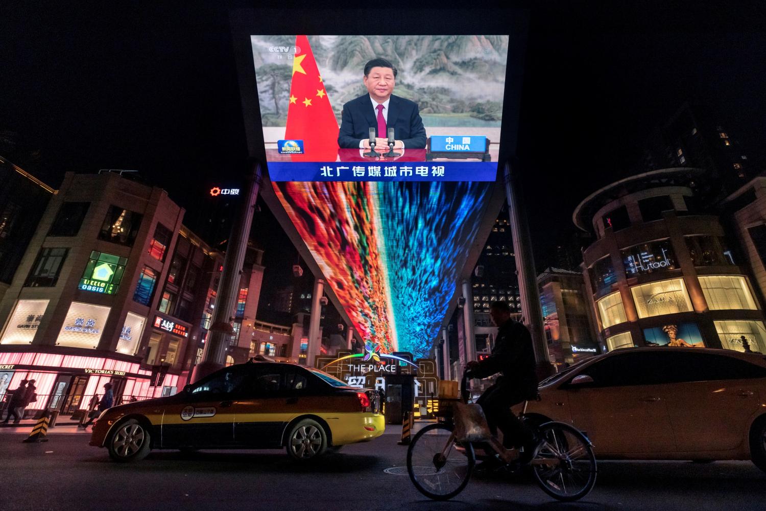 FILE PHOTO: A screen displays a CCTV state media news broadcast showing Chinese President Xi Jinping addressing world leaders at the G20 meeting in Rome via video link at a shopping mall in Beijing, China, October 31, 2021.  REUTERS/Thomas Peter/File Photo