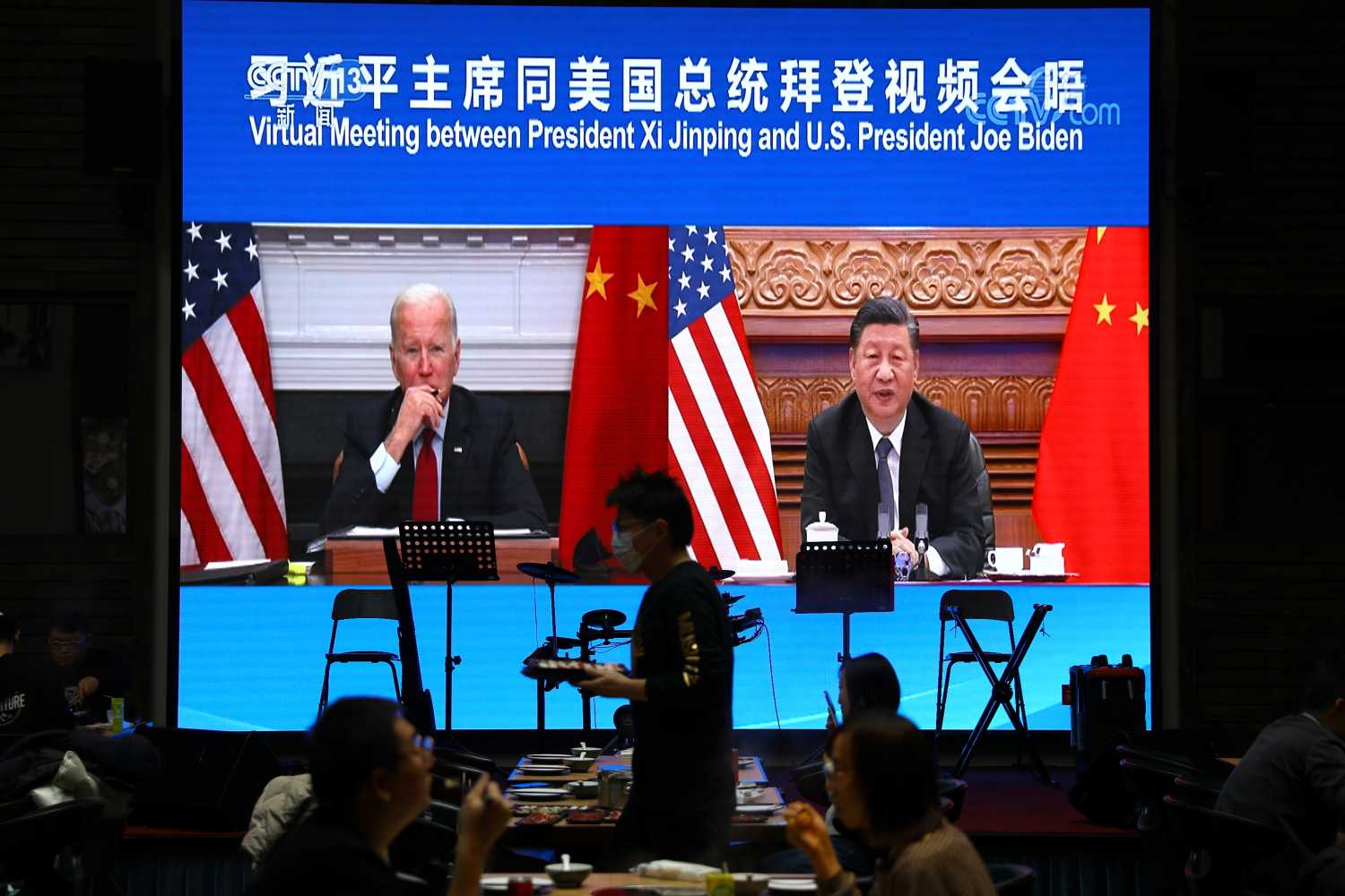 A screen shows Chinese President Xi Jinping attending a virtual meeting with U.S. President Joe Biden via video link, at a restaurant in Beijing, China November 16, 2021. REUTERS/Tingshu Wang