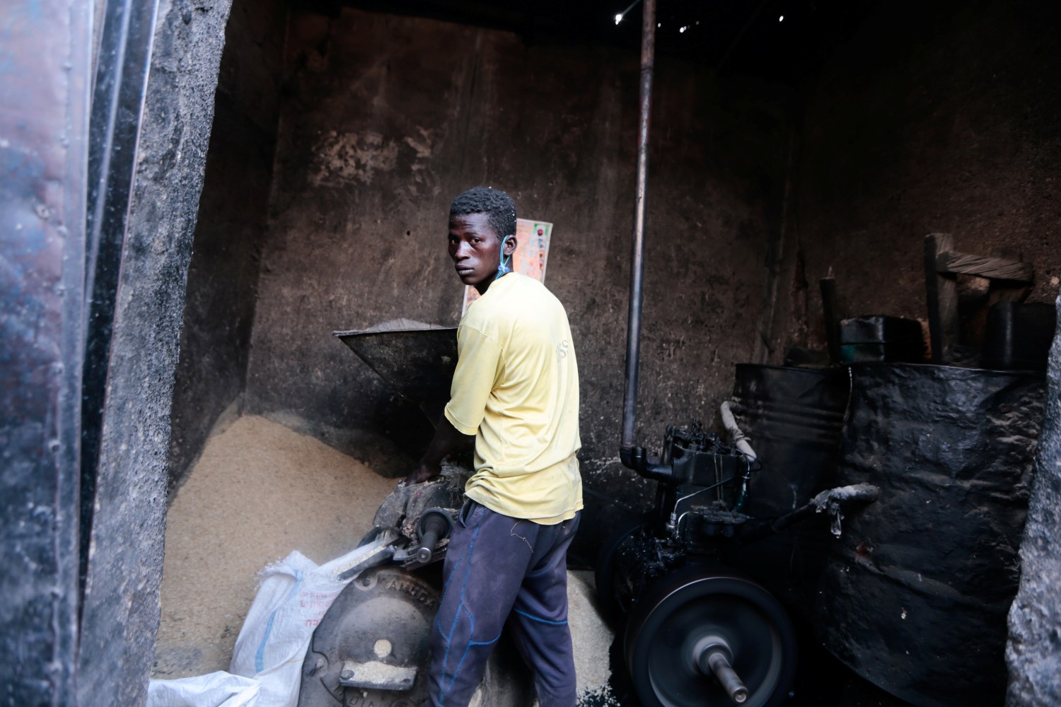A man grinds grains at a store in Maiduguri, Nigeria October 31, 2021. Picture taken October 31, 2021. REUTERS/Afolabi Sotunde