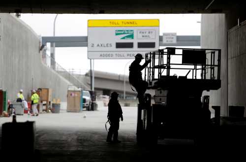 Workers are pictured, near the exit of the southbound lanes of the double deck State Route 99 highway tunnel, under construction in Seattle, Washington, U.S., March 27, 2018. REUTERS/Jason Redmond