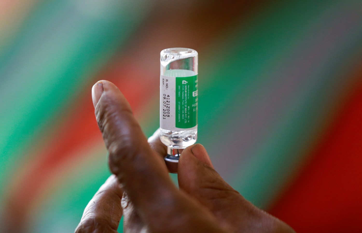 A healthcare worker holds a vial with the Oxford/AstraZeneca coronavirus disease (COVID-19) vaccine at the National hospital in Abuja, Nigeria, March 5, 2021. REUTERS/Afolabi Sotunde