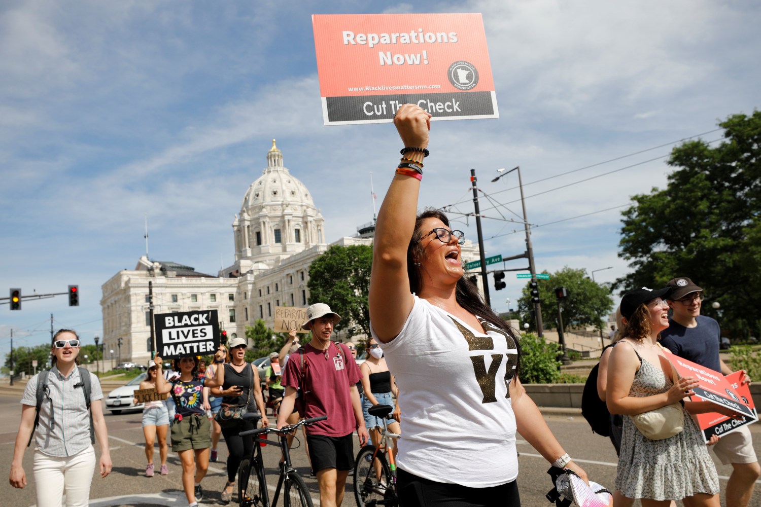 People march past the Minnesota State Capitol during the Reparations Juneteenth Celebration on Juneteenth, which commemorates the end of slavery in Texas, two years after the 1863 Emancipation Proclamation freed slaves elsewhere in the United States, in St Paul, Minnesota, U.S., June 19, 2021.  REUTERS/Nicholas Pfosi