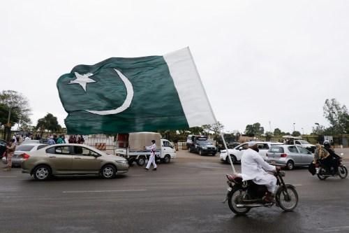 A man with a national flag on his bike rides during the celebrations of Independence Day, amid the coronavirus disease (COVID-19) pandemic, in Karachi, Pakistan August 14, 2021. REUTERS/Akhtar Soomro