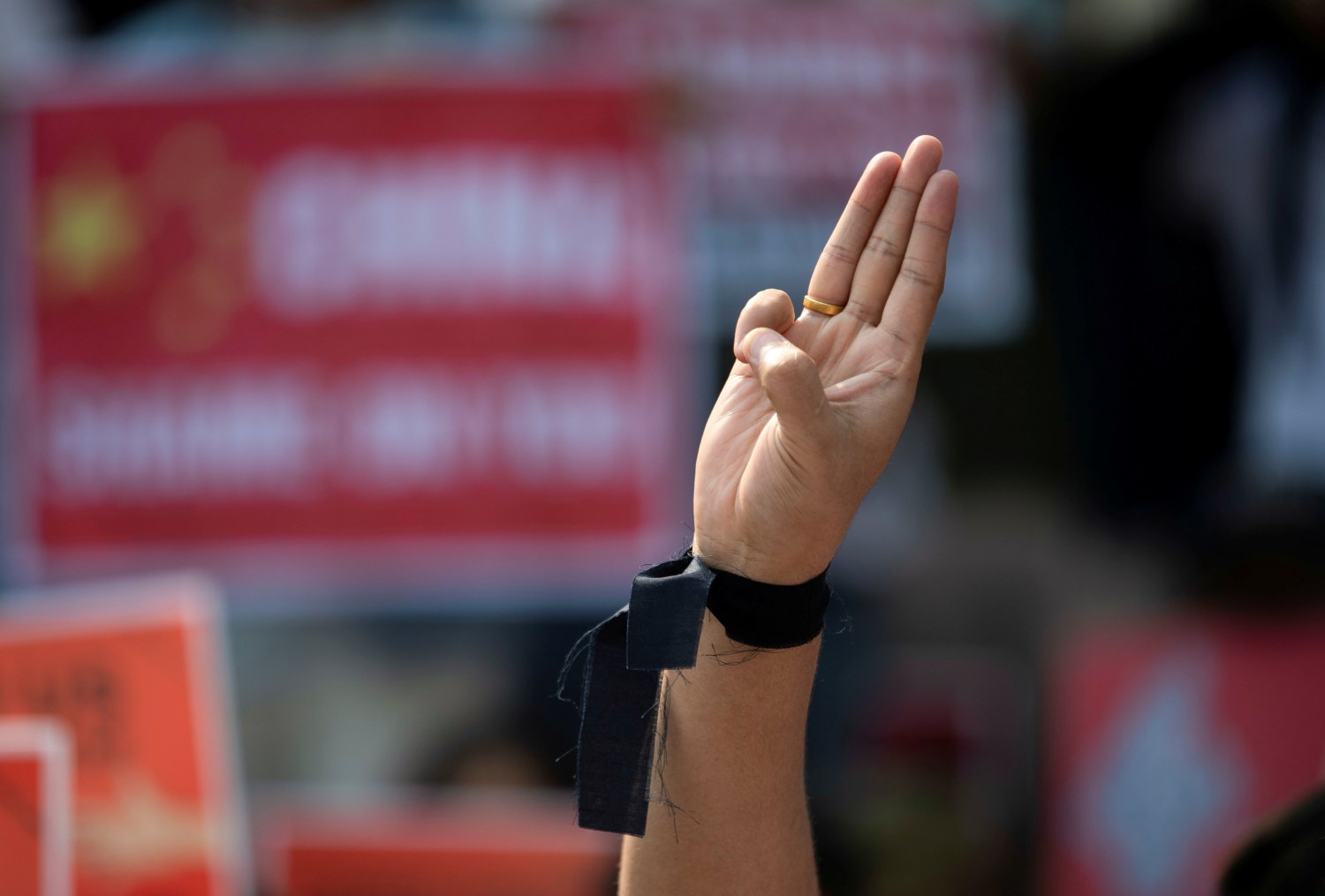 A demonstrator shows the three-finger salute during a protest against the military coup in Yangon, Myanmar, February 21, 2021. REUTERS