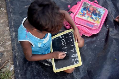 A child in India learns to read.