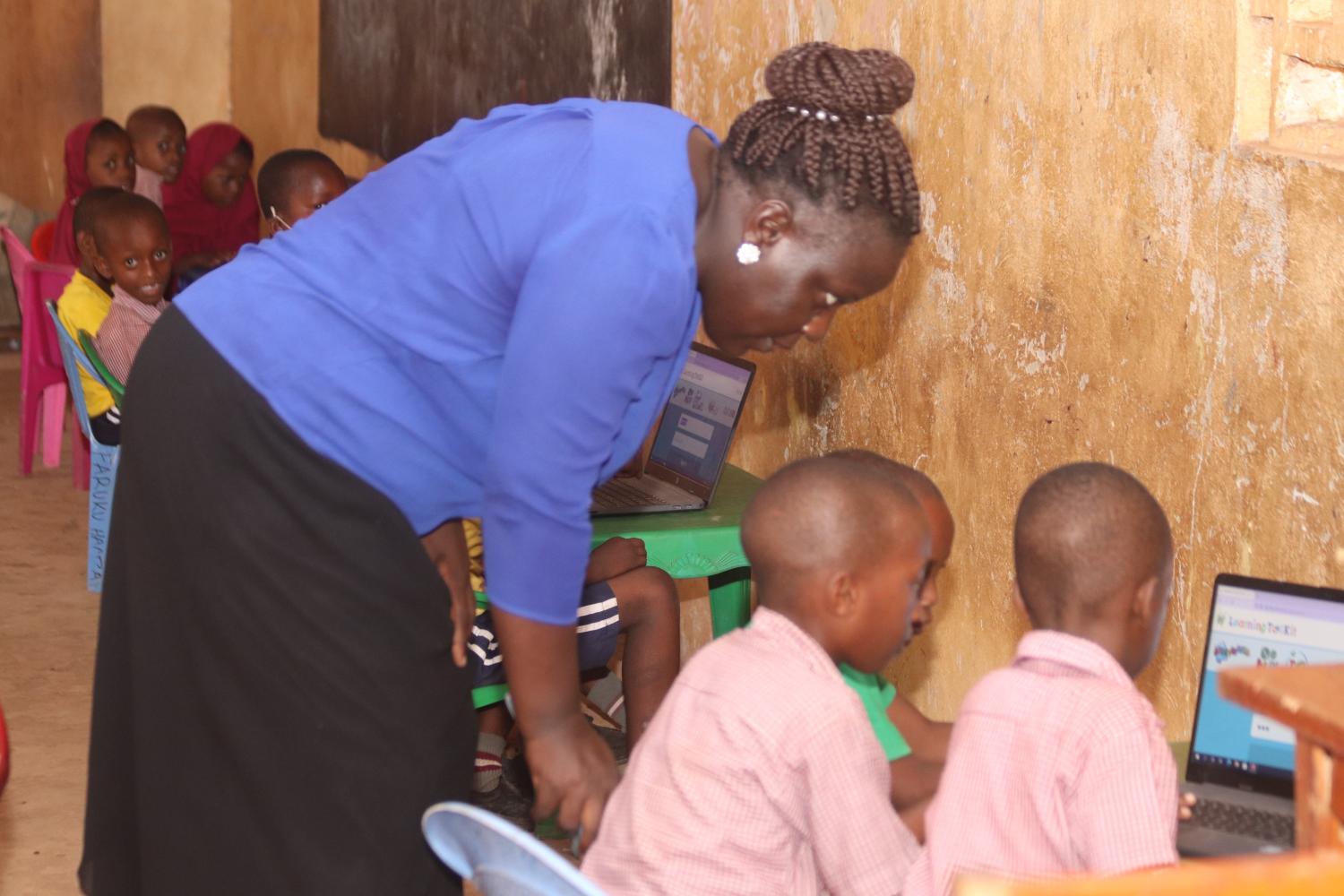 A teacher demonstrates a math activity to the whole class during a Catch Up (TaRL) session in Zambia.