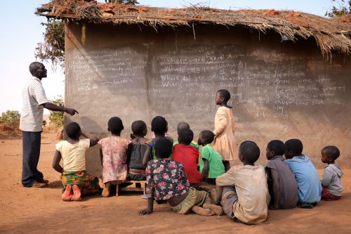 Children in Malawi learn at an outdoor school.