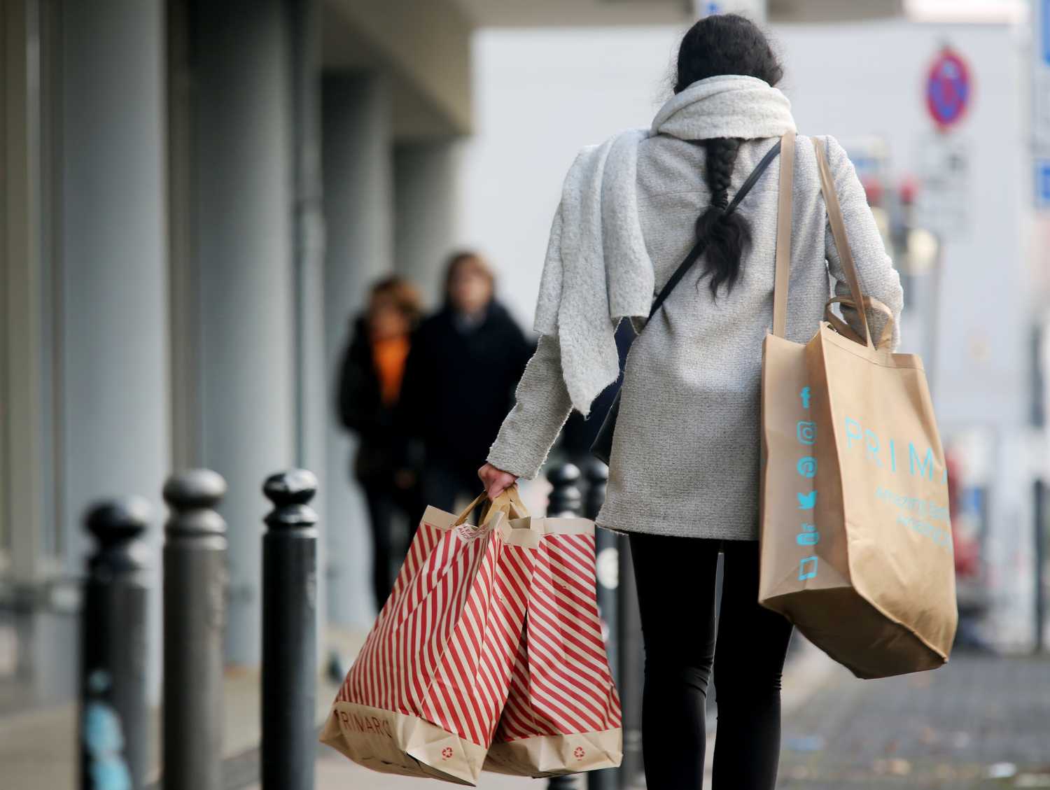 A woman carries shopping bags downtown on Saturday of the first weekend of Advent.