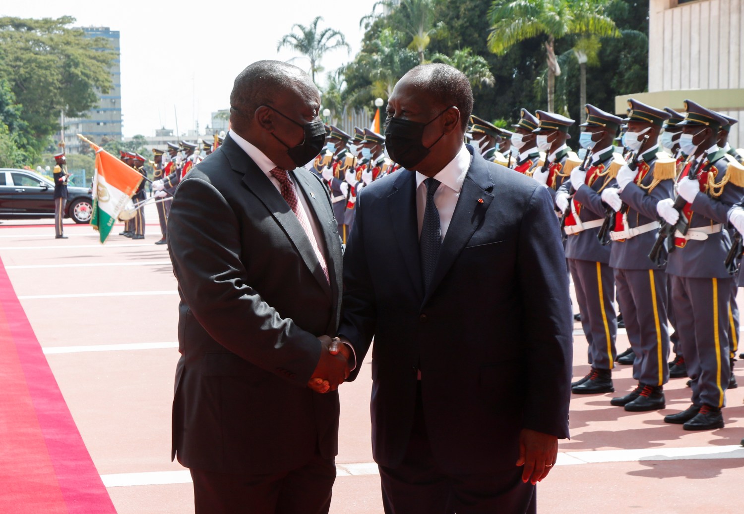 South African President Cyril Ramaphosa shakes hands with Ivory Coast's President Alassane Ouattara at the the presidential palace in Abidjan, Ivory Coast December 2, 2021. REUTERS/Luc Gnago