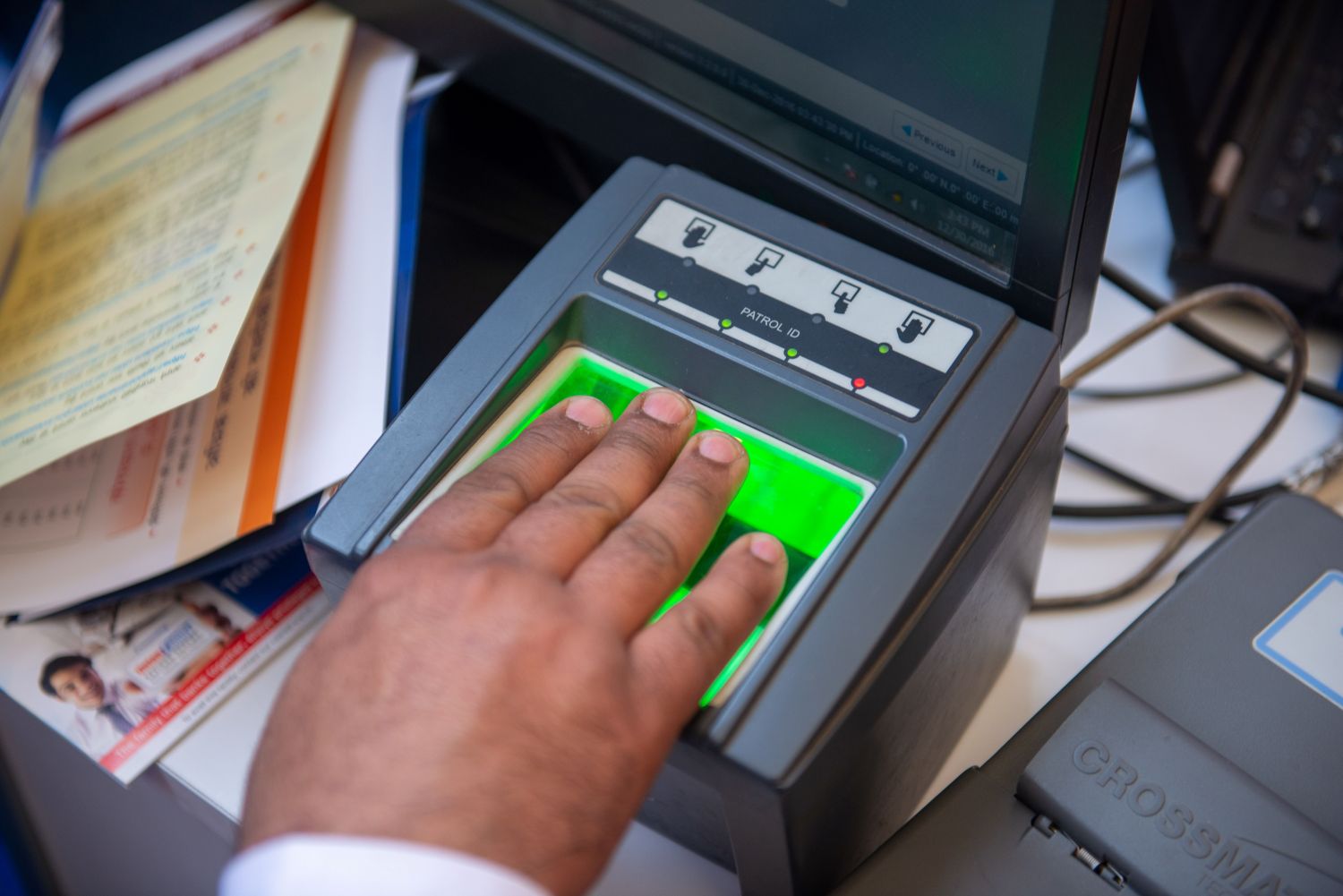 New Delhi, India- December, 30 2016: A volunteer of Aadhaar enrollment center capture biometric info of Fingerprints from a man during registration for Aadhaar card or unique identifier card.